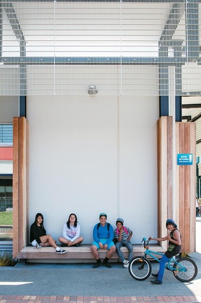 Whakatane youngsters sitting proudly in front of their new library and exhibition centre.