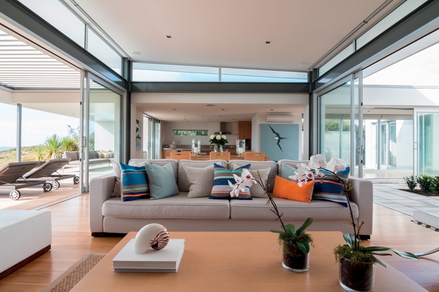 A high stud and outdoor spaces on both sides give the sense of the living area being almost marquee like.