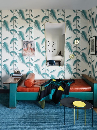 Sitting room. Wallpaper is Palm by Cole and Son; carpet by Stepevi Bed: Jean Prouvé 1950; coffee table is by Kangourou from Mathieu Matégot; mirror is by Gio Ponti; artwork is by Paul Kowan.