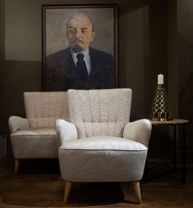 Two 1930s Scandinavian armchairs, upholstered in moiré fabric, sit under Lenin's disapproving gaze in Hall's furniture gallery.