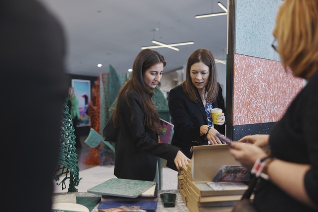 Attendees visit designers in the Exhibition Space.