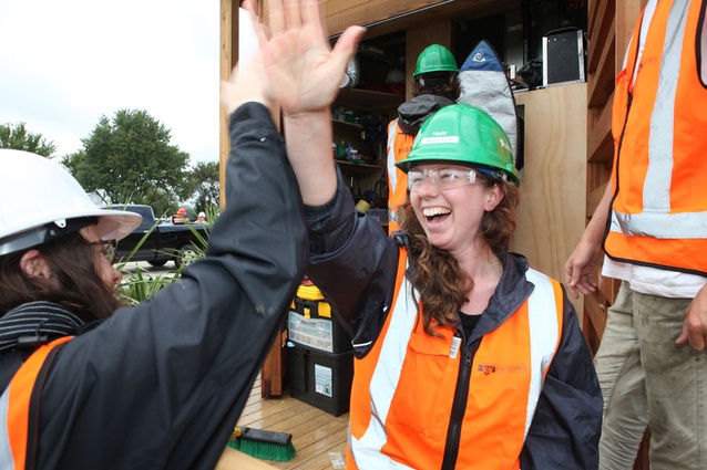 Amanda Crosby, right, and Belinda Dods of New Zealand celebrate placing the final screw on the deck of their house at the U.S. Department of Energy Solar Decathlon in Washington, D.C., Tuesday, Sept. 20, 2011. 
