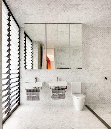Fan-shaped marble tiles cover the bathroom’s floor, walls and ceiling, creating a sense of luxury.
