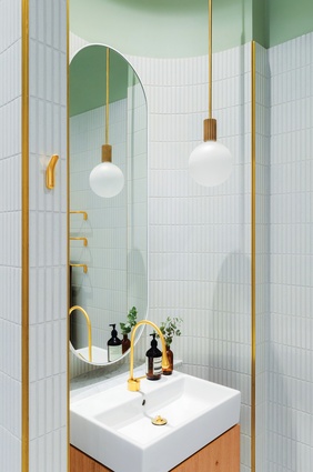 Fluting and arches are repeated in the ground-floor bathroom where curves enclose and define the basin.