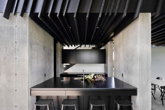 Sleeve House, Hudson Valley, United States, by Actual Office Architects. 2017. The ceiling is created by blackened wood, which contrasts perfectly with the exposed concrete flooring and walls.