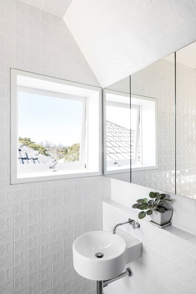 Patterned tiles add subtle texture to the bathroom wall.