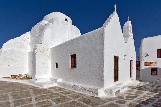 Church of Panagia Paraportiani, Mykonos, Greece. Mykonos boasts a strong Cycladic identity, with cubic-shaped architecture that provides protection from strong winds, whitewashed walls and coloured windows.