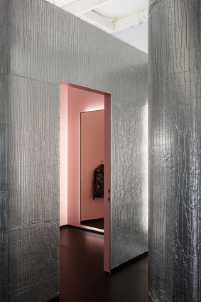 The fitting room colour in a tint of 'drunk tank pink’ — the colour of choice for police holding cells — was chosen for its calming effect.