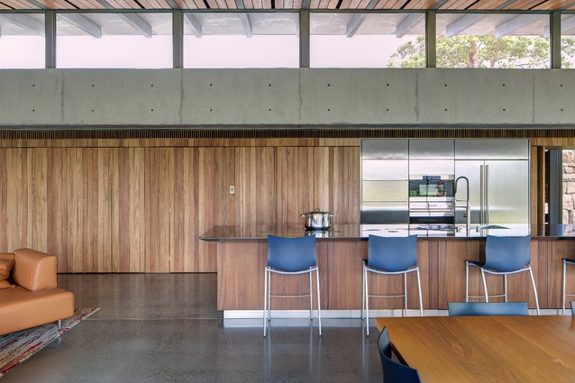 The warm tones of the custom island bench and kitchen wall in the public pavilion contribute to the sense of it being connected to its site.
