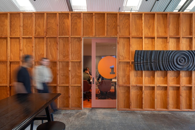 A glance past the rough timber walls into the quite work stations.