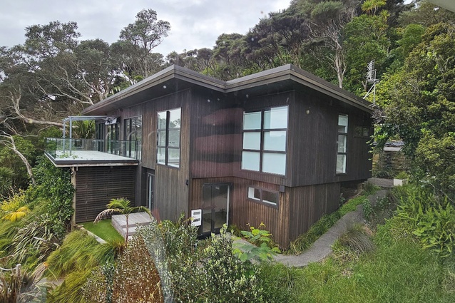 Some houses for removal remain in perfect condition; this one stands below an unstable cliff face.