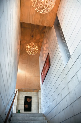 The stairs rise between the two concrete boxes and arrive in the centre of the house.   