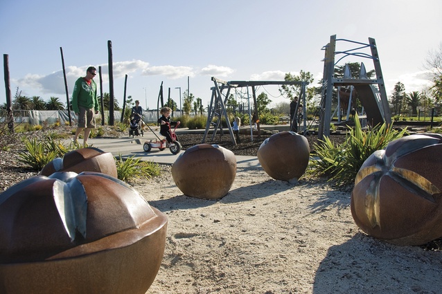 Hobsonville Point Park playground, with steel-seed play structures developed with Cicada, and an artwork by John Reynolds visible in the background.