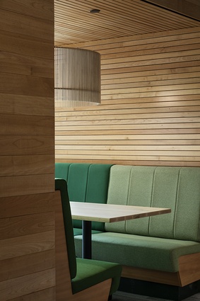 Social spaces in warm tones counterbalance the industrial feel of the more private work zones.