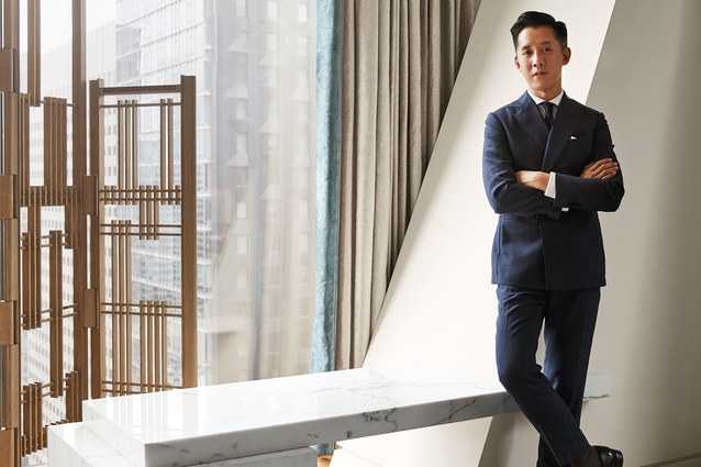 André Fu stands by a custom Carrara marble counter in his firm’s New York project 53W53 Residence.