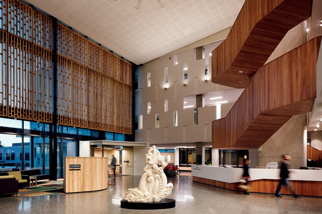 Burwood Hospital’s new foyer is rich in texture, culture and architecture, featuring a curvaceous timber stairwell, a striking carving by artist Riki Manuel and a cosy lounge area.