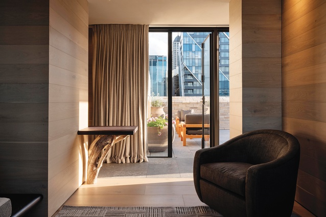 Two of the Level 10 suites open to generous terraces with outdoor fireplaces, overlooking the city.