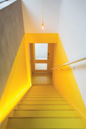 The yellow staircase introduces a sense of ceremony for staff and clients entering the new flexible workspace. 