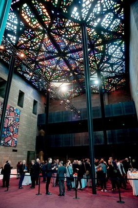 Attendees gather informally under the spectacular stained-glass ceiling in the National Gallery of Victoria’s Great Hall, designed by Australian artist Leonard French.