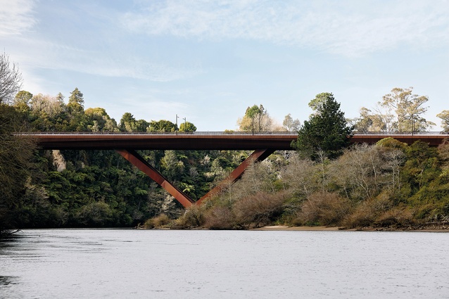 Corten balusters dissolve the massive bulk of the bridge into a surprisingly soft tectonic form.