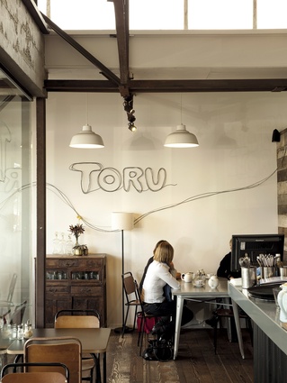 An interior view of Toru, a natural and contemporary styled café that sits comfortably under the rustic and industrial influences.