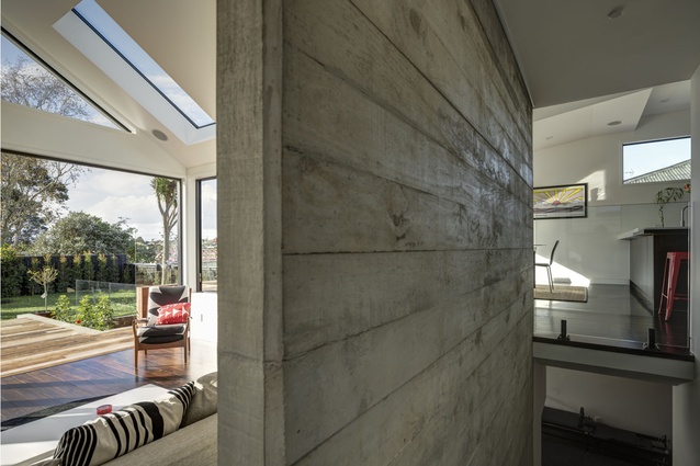 The off-shutter concrete wall in the new lounge marks the position of the original external villa wall. 