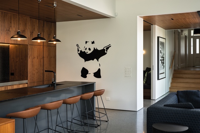 Grey Lynn House. The kitchen incorporates walnut cabinetry and panda art.