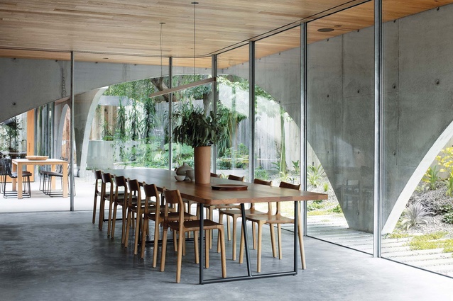 Layers of concrete, glass and screening wrap effortlessly around a rich interior.