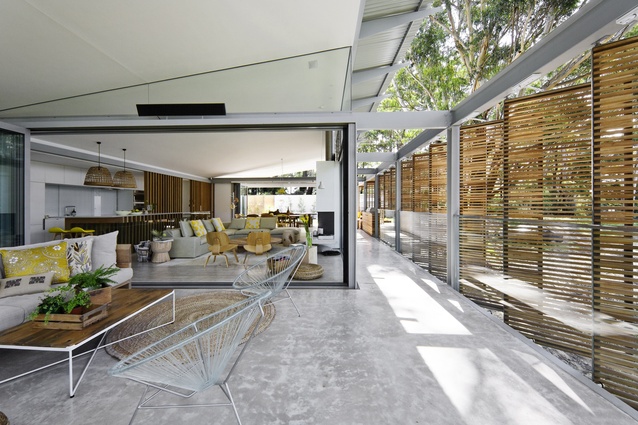 The living room of the Australian home can be almost completely opened up to the surrounding bush. 