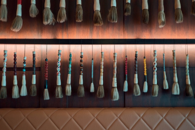 A display of calligraphy brushes adorns one wall.