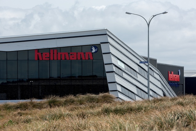 On the way to and from Auckland Airport, the Hellmann Worldwide Logistics building reveals itself among the sharply landscaped mounds of gravel and planting. 