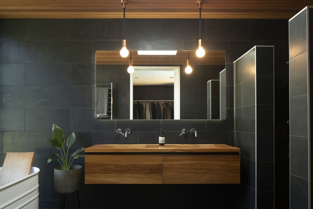 The juxtaposition of light and dark continues in the master bathroom. The white <a 
href="https://www.matisse.co.nz/brands/agape1/vieques-bath"style="color:#3386FF"target="_blank"><u>Agape bath</u></a> was one of the last pieces chosen, as the owners wanted a perfect fit.