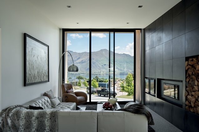 Cosy and intimate in size, with a gas fireplace in a tiled wall, the living room looks out to the mountain view. 
