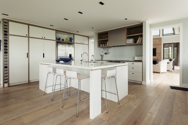 Band-sawn oak flooring is used throughout the house, and is extended to the cabinetry borders in the kitchen.