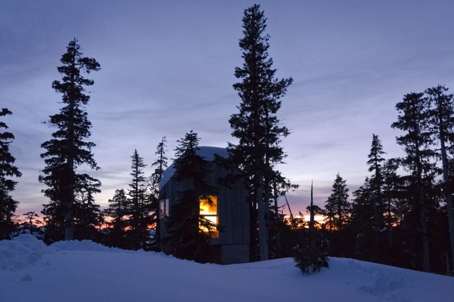 An exterior view of the cabin at sunset. 