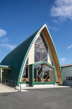 The vaulted church in its humble cloak of corrugated iron on curved glue-laminated-timber arches.