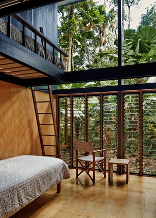 The bedroom’s double-height volume addresses the scale of the forest while easily accommodating bunk beds.
