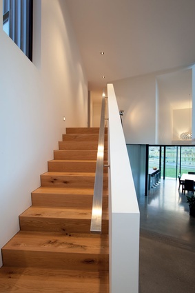 A simplified material palette includes polished concrete downstairs and American oak upstairs.