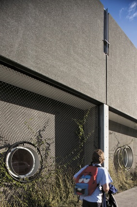 The portholes of the northern facade are surrounded by wall plantings trained to wire mesh. 