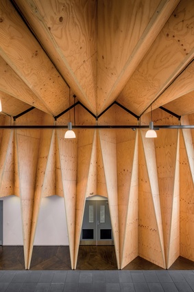 Triangular billets of LVL are folded to form walls and ceilings that wriggle across the building.