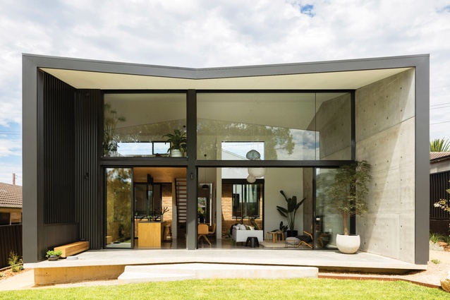 The interior of the “voluminous, open and public” addition reaches as high as the entire roof of the front house.
