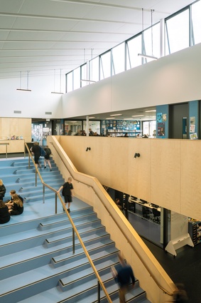 Top-lit, double-height circulation spaces form central gathering areas.