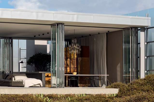 The house is designed to provide both protection and outlook, with spaces opening to a translucent glass screened courtyard to the south and a terrace overlooking the sand dunes and beach to the north. 