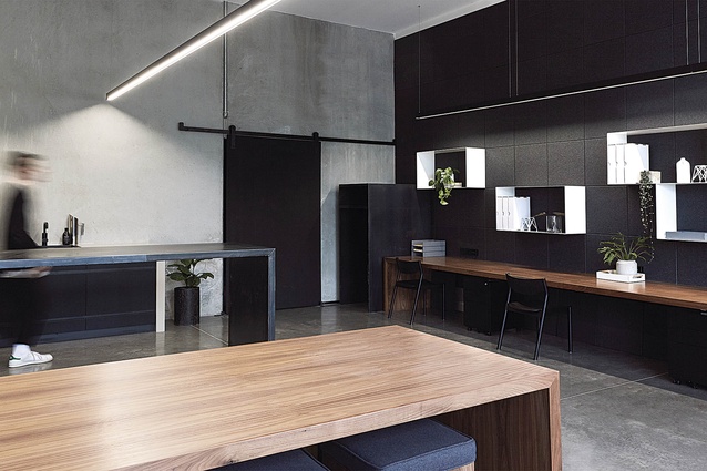 A raw palette of black, concrete and timber allows for a blank canvas for those who use the space. 