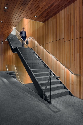 The scissor staircase’s walls and ceiling are lined in timber, with stone tiling on the floor.
