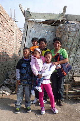 A local family in front of their house of the past four years.