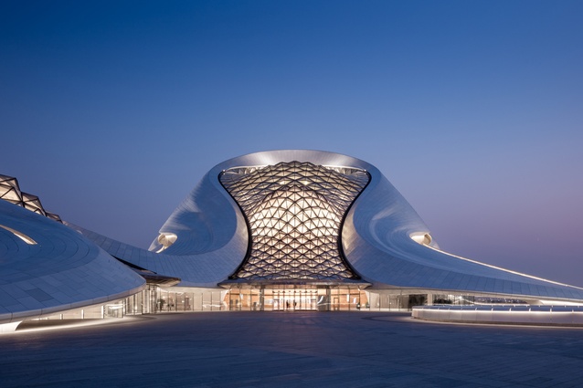 Harbin Opera House, China. Clad in white aluminium panels and glass, the undulating form of this enormous arts complex wraps around two concert halls and mirrors the curves of the marsh landscape.