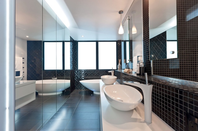 The freestanding bath and glass feature wall provide a sense of contemporary luxury.