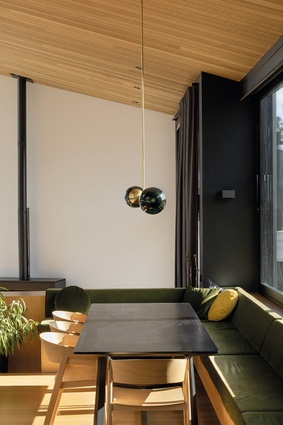Colour and texture are provided by built-in furniture with soft yellow and green fabrics, and by sculptural light fixtures, such as the Douglas & Bec <a 
href="http://www.douglasandbec.com/products/line-pendant-02"style="color:#3386FF"target="_blank"><u>Line Pendant</u></a> above the dining table.