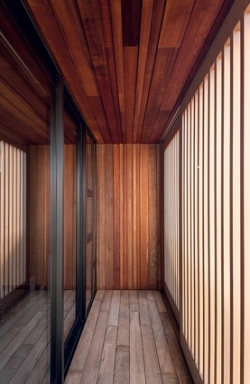 The first-floor balcony is lined with cedar panelling and plantation-grown hardwood decking.